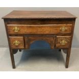 Early 19th century oak lowboy, the moulded top above an arrangement of one long and two square