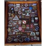 Good case of European and Asian motor vehicle badges, enamel and otherwise, to include: Stoewer,