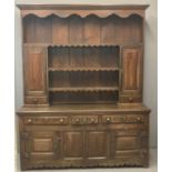 Part 18th century oak rack back dresser, the moulded cornice above carved frieze with boarded