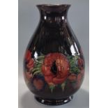 Mid century Moorcroft pottery tube lined 'Anemone' vase, on a black ground, of baluster form,