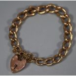 9ct gold curblink bracelet with heart padlock. 32.5g approx. (B.P. 21% + VAT)