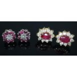 Pair of 18ct gold diamond and ruby earrings, the central ruby surrounded by ten diamonds, together