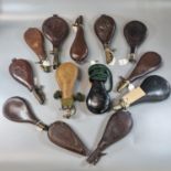 Large collection of mainly leather shot flasks with metal dispensers, some with repoussé decoration,