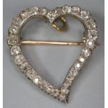 Gold and diamond heart shaped brooch, set with approximately 30 diamonds, appearing unmarked. 2cm