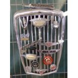 Post war Wolseley chrome radiator grill set with an assortment of Wolseley car badges and scripts.