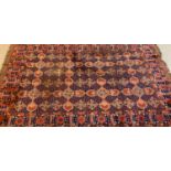 Terracotta ground Afghan carpet with multi repeating geometric designs. 313 x 204cm approx. (B.P.