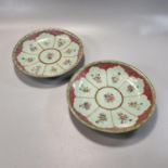 Pair of Chinese porcelain celadon glaze Famille Rose enamelled dishes, with posies of flowers in a