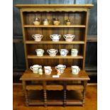 Reproduction miniature mahogany dog kennel dresser comprising assorted miniature china including