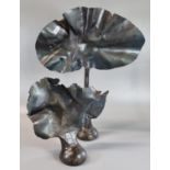 Two modern patinated steel sculptures/door stops worked to represent a tree and a bush. The