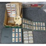 Box of cigarette cards and cigarette card albums to include; Player's; birds, cars, flags etc,