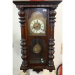 Early 20th century stained walnut two train Vienna type wall clock, with key and pendulum. (B.P. 21%