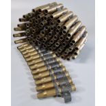 A belt of inert fired brass machinegun cartridges. (B.P. 21% + VAT)