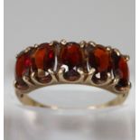 9ct gold red five stone dress ring. Size N. 2.3g approx. (B.P. 21% + VAT)