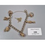 9ct gold charm bracelet, to include: heart shaped padlock, spinning wheel, fish, bird etc. 23g