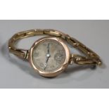 9ct gold vintage ladies wristwatch with Arabic face and seconds dial on plated expanding bracelet.