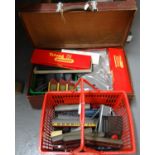 Vintage suitcase and shopping basket containing a collection of Tri-ang Hornby 00 gauge railway