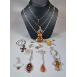 Collection of continental silver and amber jewellery, to include: pendants on chains, Amber cross