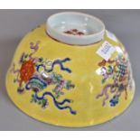 Chinese porcelain bowl, painted in famille rose enamels on a yellow ground, depicting the eight