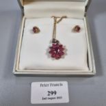 Pair of 9ct gold ruby earrings together with a 9ct gold and red stone flowerhead pendant and