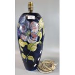 Moorcroft pottery tube lined table lamp on a blue ground with floral designs. 38cm high approx. (B.