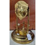 Brass perpetual motion mantle clock, lacking its dome. 28cm high approx. (B.P. 21% + VAT)