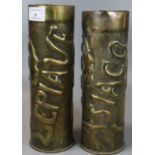 Two similar brass trench art shell cases with repousse decoration of birds, trees and foliage. One