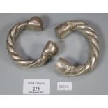 Two similar Arabic white metal torque bangles. (B.P. 21% + VAT)