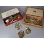 Vintage Elastoplast tin containing a collection of antique horse brasses and copper plaques.