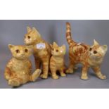 Two Winstanley studio Art pottery ginger tabby cats, together with a Winstanley figure group of