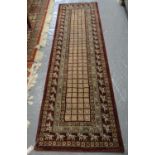 Burgundy ground Middle Eastern design runner repeating square flowerhead panels, the borders