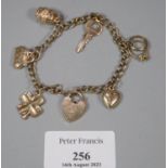 9ct gold charm bracelet to include: heart padlock, ladies bag, barrel, key, ring etc. 12.5g