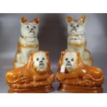 Pair of early 20th Century Staffordshire fireside recumbent lions with glass eyes. Together with a