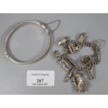 Silver charm bracelet with assorted charms, to include: rugby ball, double decker bus, heart