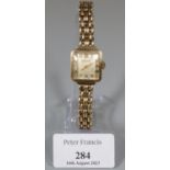 Accurist 9ct gold square faced ladies mechanical wristwatch with 9ct gold chain bracelet. 25.7g