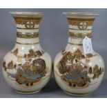 A mirror matched pair of Japanese Satsuma earthenware vases decorated in polychrome moriage
