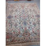 Middle Eastern hand knotted carpet on a cream ground, overall decorated with multi coloured floral