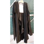 Long black academic robe with long sleeves and 'A.G Almond Ltd, Sidney St, Cambridge' label.