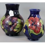 Moorcroft tube lined Art pottery 'Anemone' blue ground baluster vase. Impressed and painted initials