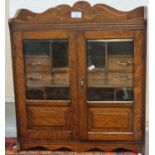 Large early 20th century oak two door glazed smoker's cabinet. (B.P. 21% + VAT)