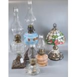 Group of assorted lamps to include: four brass single burner oil lamps, two with cast metal bases,