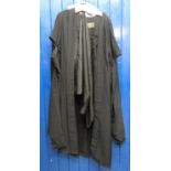 Long black academic robe with long sleeves and 'A.G Almond Ltd, Sidney St, Cambridge' label.