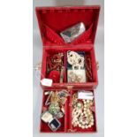 Simulated snake skin jewellery box containing a collection of assorted costume jewellery,