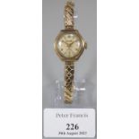 9ct gold 'Everite' ladies wristwatch with Arabic numerals and seconds dial, on plated expanding