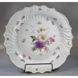 Large Meissen porcelain platter with painted decoration of flowers and butterflies, within a moulded