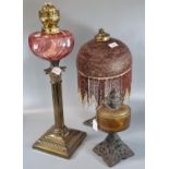 Early 20th century brass double burner oil lamp with cranberry reservoir and brass Corinthian column