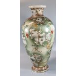 Large Japanese Kutani pottery baluster shaped vase with overall foliate and floral decoration.