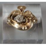 Yellow metal floral design diamond solitaire ring. 6.1g approx. Ring size J1/2. 0.2ct approx. (B.