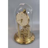 Kern German made brass perpetual motion dome clock, with glass dome. Overall 31.5cm high approx. (