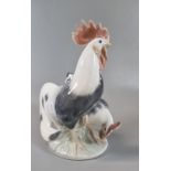 Royal Copenhagen porcelain group of a cock and hen chickens. Printed and painted marks to the