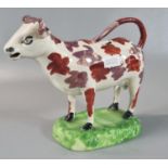 19th century Swansea Pottery cow creamer with red and and lustre splash decoration on naturalistic